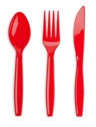Red plastic knife, fork and spoon isolated on white