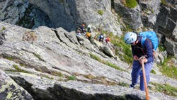 rock climbers traverse and climb the Clocher de Planpraz climbing route in the French Alps above Chamonix