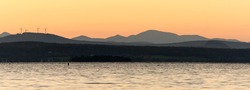 Lake Champlain in Vermont at sunset with mountains in the background