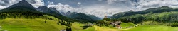 panorama view of the lower Engadin valley near Scuol in the Swiss Alps with the village of Tarasp and its castle in the foreground