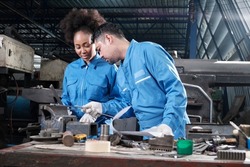 Two professional industry workers teams in safety uniforms and engineers' partners worked with metalwork tools, checked mechanical precision for lathe machines, and workshops in manufacturing factory.