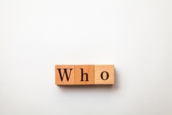 Who character. Who. Interrogative pronoun. Written on three wooden blocks. Black letters. White background.