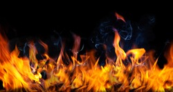 Fire flames and Smoke on black color background . Image of burning fire for decorative special effect . 