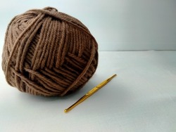 knitting needles, lumps of brown yarn, on a white background
