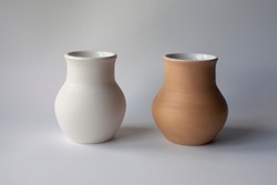 Two ceramic milk pots of white and terracotta clay. Rustic style.