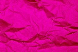 Texture of magenta crumpled paper. Pink background.