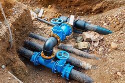 Excavated water pipes for repair and replacement. Plumbing industry concept
