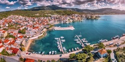 Aerial panorama of a scenic resort town Neos Marmaras with yacht marina sea port in Halkidiki, Sithonia. Travel attractions and vacation in Greece