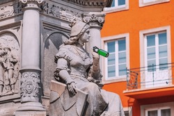 Statue in Cologne old town drinking beer. German Octoberfest and joke and alcohol abuse concept