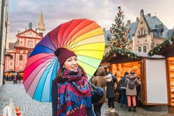 Traveler woman choosing Christmas gifts at market in New Year time