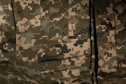 Close-up of the surface of the military uniform of the Ukrainian military