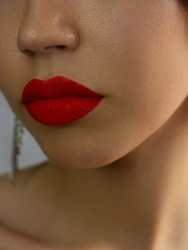 Close-up of woman's lips with fashion bright pink make-up. Beautiful female mouth, full lips with perfect makeup. Part of female face. Choice lipstick. Pink wavy hair of a doll
