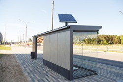 Set of solar panels on contemporary bus stop on street