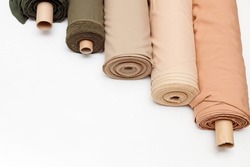 pastel color fabric rolls isolated on white, Synthetic and natural fabrics with copyspace.