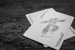 Joker card on wooden floor,Black and white pictures