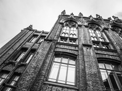 Historical architecture. A century old school building. Old brick school building in black and white. 