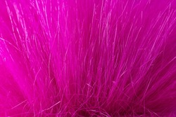 Colorful pink artificial fur soft and warm textured. Faux fur background
