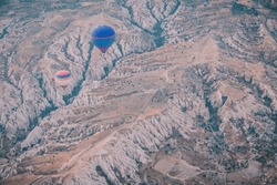 Hot air balloons over Cappadocia area in Turkey. Spectacular view of hot air balloons and Cappadocia in sunrise light.