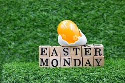 Easter Monday with eggs decoration on green grass. it is the day after Easter Sunday and is a public holiday in some countries. It is the second day of Eastertide. In Western Christianity, 