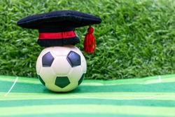 Soccer graduation with hobo hat on green grass background
