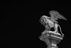 Saint Mark Lion statue, symbol of ancient Republic of Venice, made in 1870 at the of a column in 'Piazza dei Signori' (Lord's Square) in the center of Padua (Black and White with copy space)