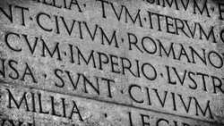 Latin ancient language and classical education. Inscription from Emperor Augustus famous Res Gestae (1st century AD), with the word Imperio in the center (Black and White)