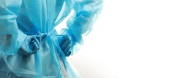 Rear view of a medical worker wearing a  protective medical suit to protect against coronavirus. Copy space in banner size.