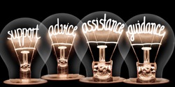 Photo of light bulbs group with shining fibers in a shape of SUPPORT, ADVICE, ASSISTANCE, GUIDANCE concept words isolated on black background