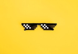 Funny swag pixilated boss sunglasses on yellow background. Gangster, Black thug life meme glasses. Pixel 8bit style