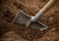 Shovel in the ground, close-up.