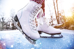 Close-up of woman ice skating on a pond on a freezing winter day