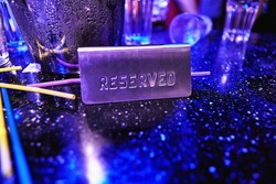 Reserved sign on a table at night club