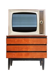 An old TV with screen noise sits on a vintage nightstand from the 1960s, 1980s, 1970s.
