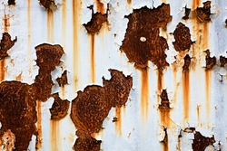 Corroded white metal background. Rusted white painted metal wall. Rusty metal background with streaks of rust. Rust stains. The metal surface rusted spots. Rysty
corrosion.