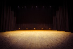 An empty stage of the theater, lit by spotlights before the performance