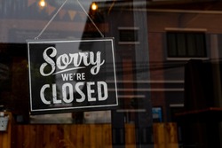 Sorry we're closed . vintage black and white retro sign on a coffee glass door