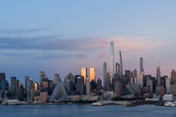 Aerial New York City skyline from New Jersey over the Hudson River with the skyscrapers of the Hudson Yards district at sunset. Manhattan, Midtown, NYC, USA. A vibrant business neighborhood