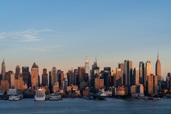 Aerial New York City skyline from New Jersey over the Hudson River with the skyscrapers of the Hudson Yards district at sunset. Manhattan, Midtown, NYC, USA. A vibrant business neighborhood