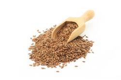 Heap of Flax seeds or linseeds in wooden scoop isolated on white background. Flaxseed concept, dietary fiber 