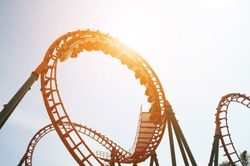blurred Roller coaster ride in amusement park at evening