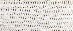 Crochet White background.  Natural, pure, organic cotton yarn being worked into a pattern of double crochet stitches. 