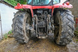 The back end of a tractor showing the power take of point and 3 point linkage,