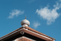 simple mosque dome, against a blue sky background