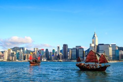 Hong Kong skyline cityscape, Tourist junk boat at Victoria Harbor in evening