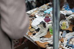 Vintage and kitsch porcelain dog statuette in an open-air flea market in Vienna Austria