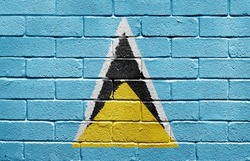 Flag of Saint Lucia painted onto a grunge brick wall