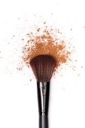 close up of a make up powder and a brush. makeup brush with powder foundation isolated on white