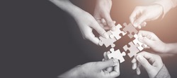 CSR (coporate social responsibility) or teamwork concept.Hands holding jigsaw.Autism awareness day kid child.business people putting jigsaw for team together.Charity, volunteer. Unity, team business.