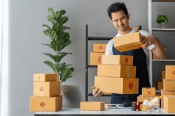 Small Business Startup Owner Asian Independent Entrepreneur Arranging multiple parcel boxes on online orders for delivery arrangements to customers, SME business concept.