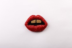 A beaded brooch in the shape of red lips